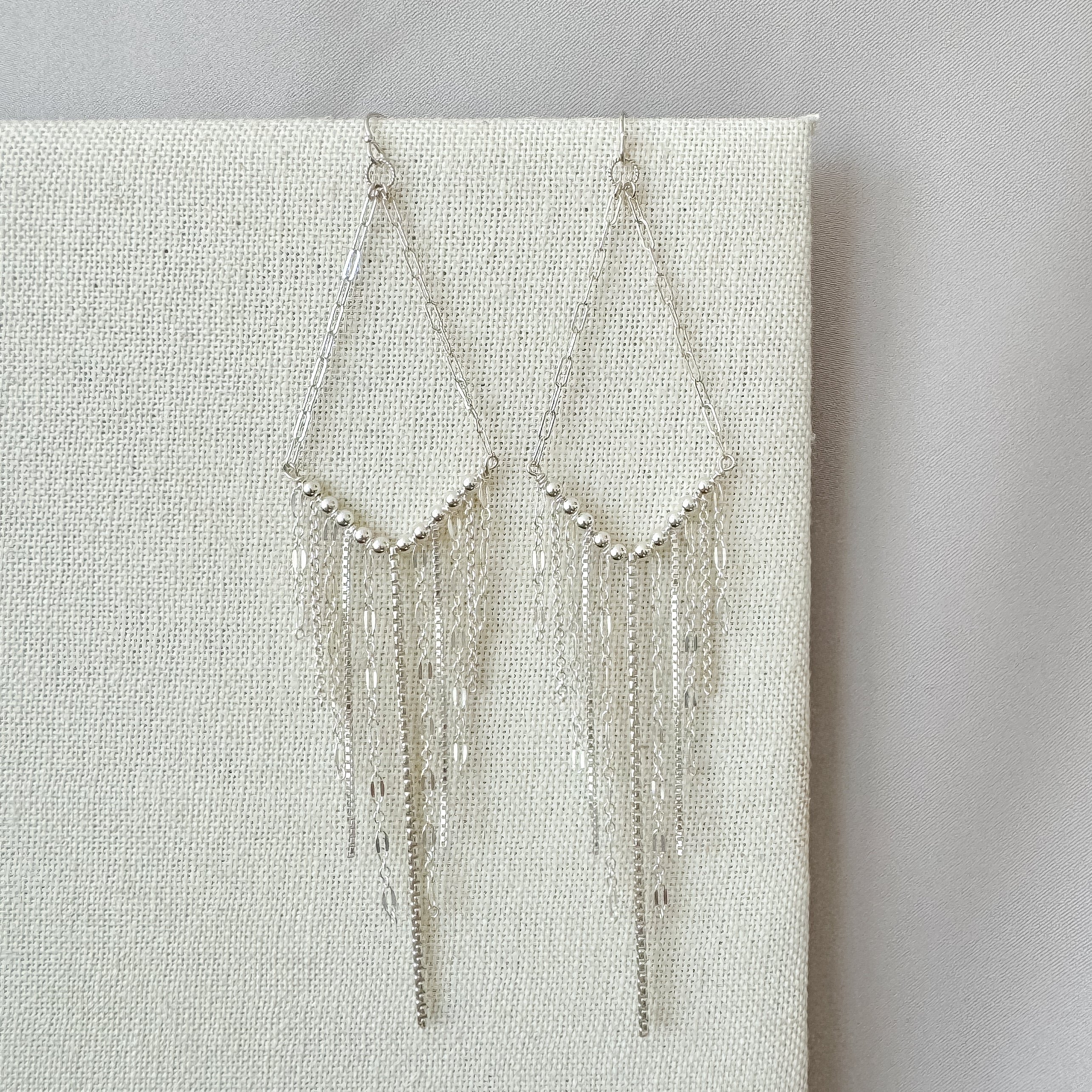 V fringe earrings